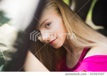 Portrait of attractive young female at car Portrait of attractive young female at car 43303597