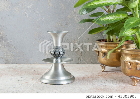 Vintage candlestick on concrete background. 43303903