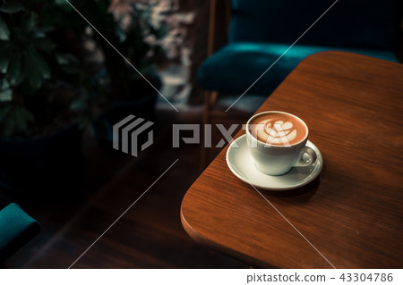 Flat white coffee latte art on wooden table 43304786