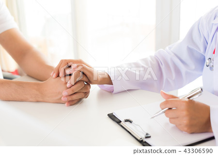 Doctor holding patient's hand. Doctor holding patient's hand. 43306590