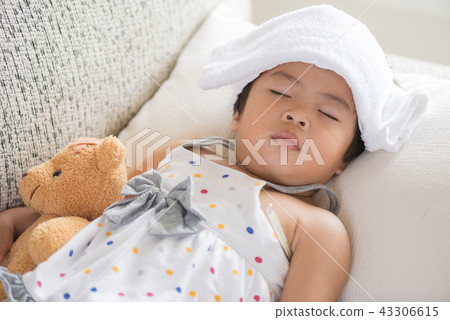 Young little girl sleeping and sick on the sofa Young little girl sleeping and sick on the sofa 43306615