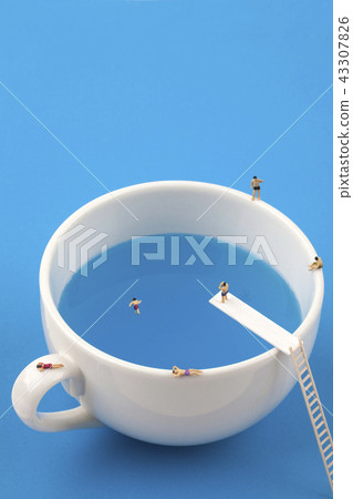 Miniature people in a mug pool Miniature people in a mug pool 43307826