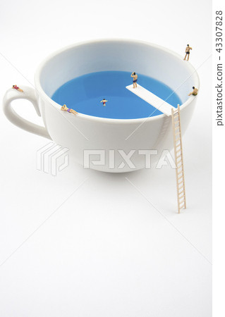 Miniature people in a mug pool Miniature people in a mug pool 43307828