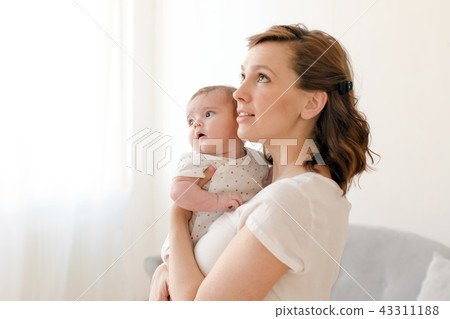 Woman holding little baby on hands 43311188