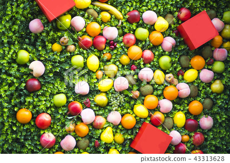 A composition of fruits on a green background. Pattern made from fresh fruits. Top view, flat design A composition of fruits on a green background. Pattern made from fresh fruits. Top view, flat design 43313628