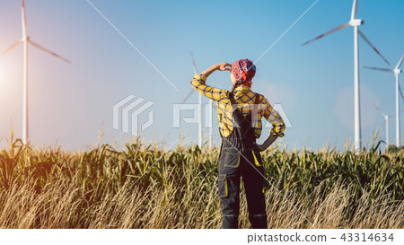 Farmer woman has invested not only in land but also wind energy Farmer woman has invested not only in land but also wind energy 43314634