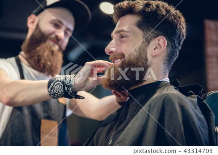 Close-up of the hands of a skilled barber using a brush Close-up of the hands of a skilled barber using a brush 43314703