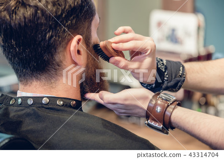 Close-up of the hands of a skilled barber using a brush Close-up of the hands of a skilled barber using a brush 43314704