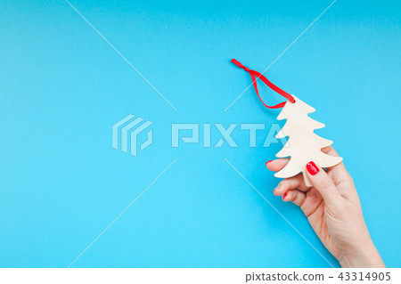 Woman hand holding homemade wooden christmas toy 43314905