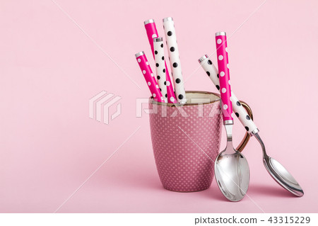 Colorful Ceramic Coffee Mugs and Spoons on Pink Colorful Ceramic Coffee Mugs and Spoons on Pink 43315229