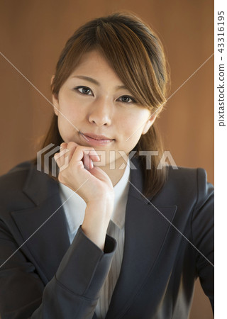 Businesswoman with a cheeks stick Businesswoman with a cheeks stick 43316195