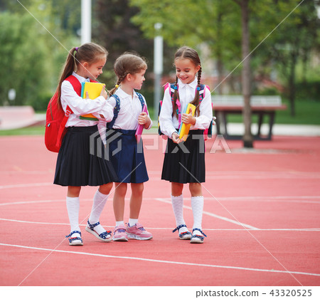 Happy children girlfriend schoolgirl student elementary school Happy children girlfriend schoolgirl student elementary school 43320525