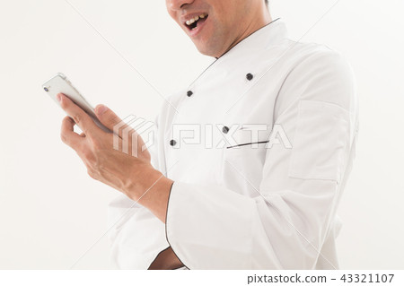 Chef looking at a smartphone Chef looking at a smartphone 43321107