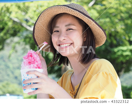 A woman eating shaved ice A woman eating shaved ice 43322312
