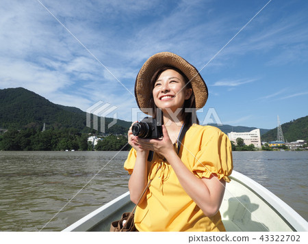 Woman taking a picture on a boat 43322702