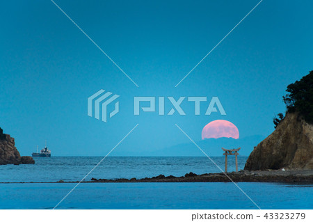 A night view of the island with a torii gate and an image of a full moon rising from the Seto Inland Sea 43323279