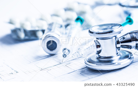 Stethoscope injections pills on the  EKG graph. 43325490