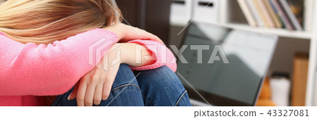 Unhappy lonely depressed woman sitting on the couch Unhappy lonely depressed woman sitting on the couch 43327081
