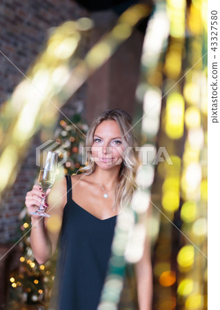 Attractive woman drinking champagne on the new Year's party 43327580