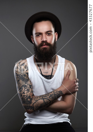 Handsome Tattooed Bearded Man in Hat Handsome Tattooed Bearded Man in Hat 43327677