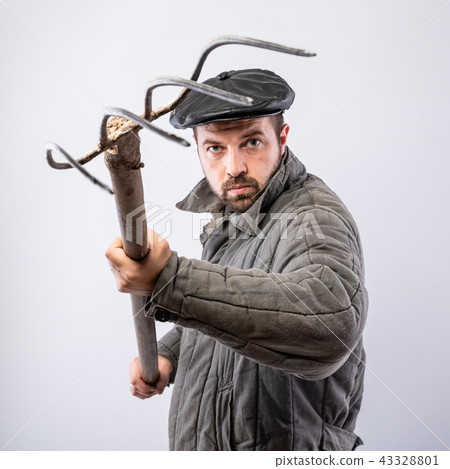 Bearded man with pitchfork in hand 43328801