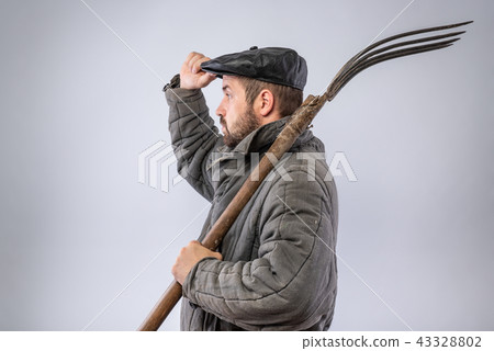 Man with pitchfork gives greeting gesture 43328802