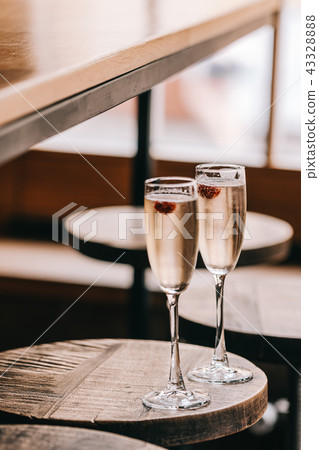 Two glasses of champaigns on wooden table 43328888