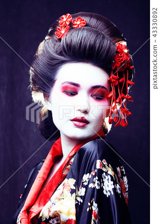 young pretty geisha in kimono with sakura and decoration on blac 43330892