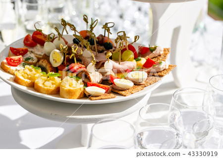 solemn banquet. Lot of glasses champagne or wine on the table in restaurant. buffet table with lots solemn banquet. Lot of glasses champagne or wine on the table in restaurant. buffet table with lots 43330919