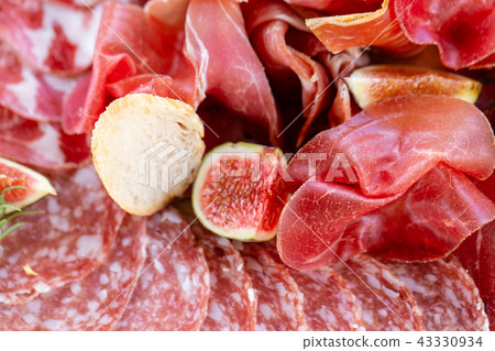 Light Italian snacks. A buffet table at a dinner party. Food tray with delicious salami, pieces of 43330934