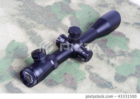 sniper scope on camouflage background 43331500