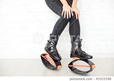 close-up in kangoo jumps boots indoors unrecognizable rear view. 43333390