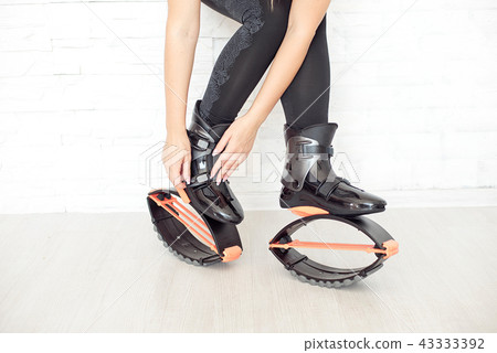 close-up in kangoo jumps boots indoors unrecognizable rear view. 43333392
