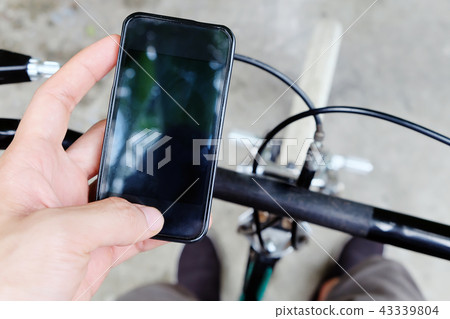 Cyclist using smartphone Cyclist using smartphone 43339804