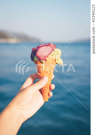 Woman's hand holding ice cream. Woman's hand holding ice cream. 43340123
