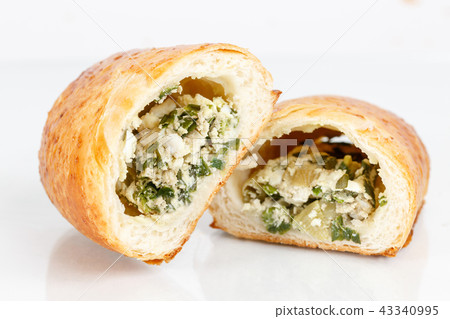 Tasty puff pastry dessert cut in half . Delicious pastries with boiled egg on light background. 43340995