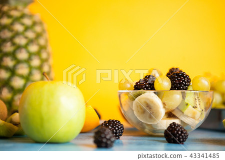 Sliced banana, grapes, kiwi and berry in a bowl 43341485