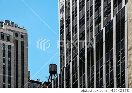 Low angle view of skyscrapers and water tank in New York Low angle view of skyscrapers and water tank in New York 43342578