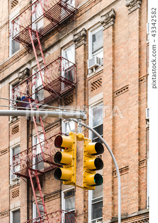 Yellow traffic lights against old building in New York Yellow traffic lights against old building in New York 43342582