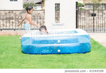 Children playing in the pool at home Children playing in the pool at home 43344599