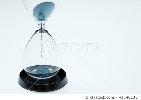 Photo of hourglass with blue sand on isolated white background, 43346138