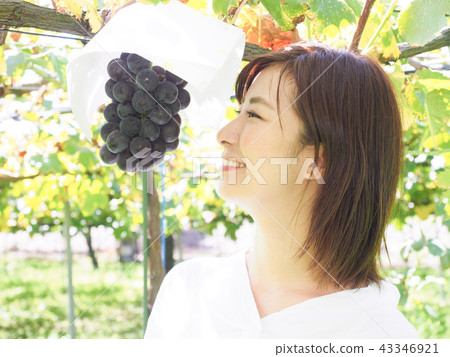 Woman staring at a grape 43346921