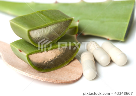 sliced aloe vera leaves and pills in spoon sliced aloe vera leaves and pills in spoon 43348667