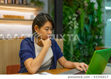 Businesswoman looking at computer laptop seriously Businesswoman looking at computer laptop seriously 43348817