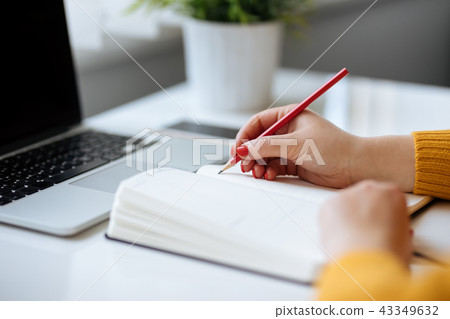 Woman writes in a diary Woman writes in a diary 43349632
