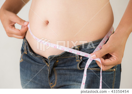 Fat woman hand measuring waist  43350454