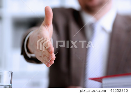 Man in suit and tie give hand as hello 43352850