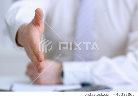 Man in suit and tie give hand as hello Man in suit and tie give hand as hello 43352863