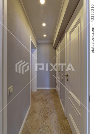 A light corridor with white doors 43353310