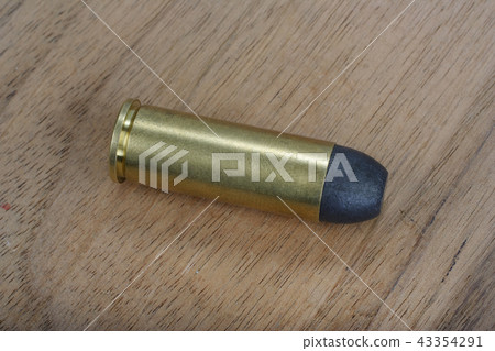 Revolver cartridges Wild West period on wood plate Revolver cartridges Wild West period on wood plate 43354291